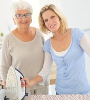 Caregiver sitting with smiling patient